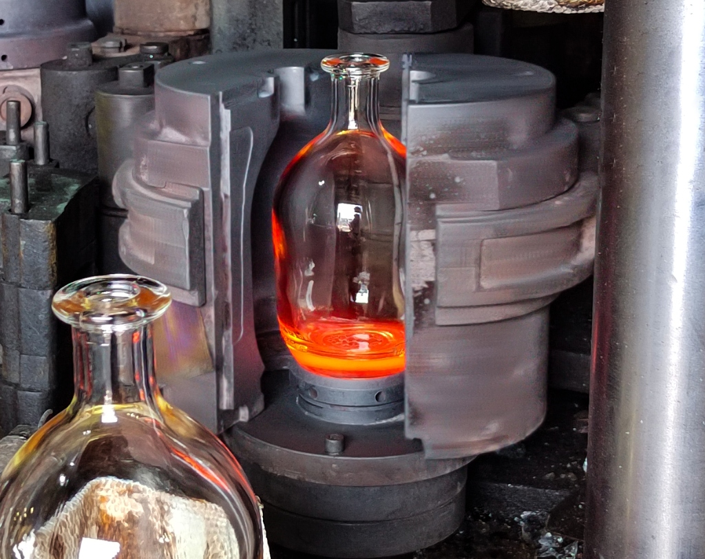 Custom glass bottle blow mold open during hot-end IS machine production line